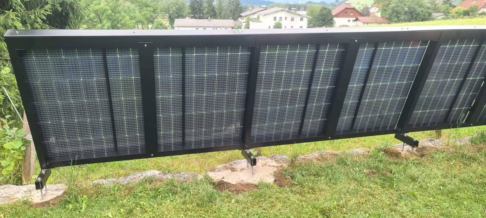 Black photovoltaic fence on a property overlooking the surroundings